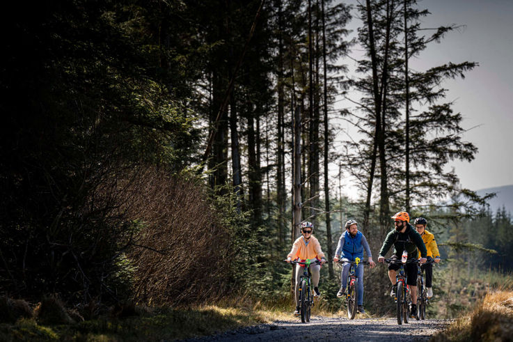 Friends riding electric bikes at Corralea Activity Centre