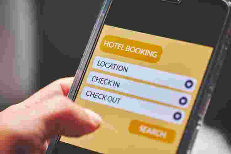 Person using smartphone for accommodation vacation deal on mobile reservation app