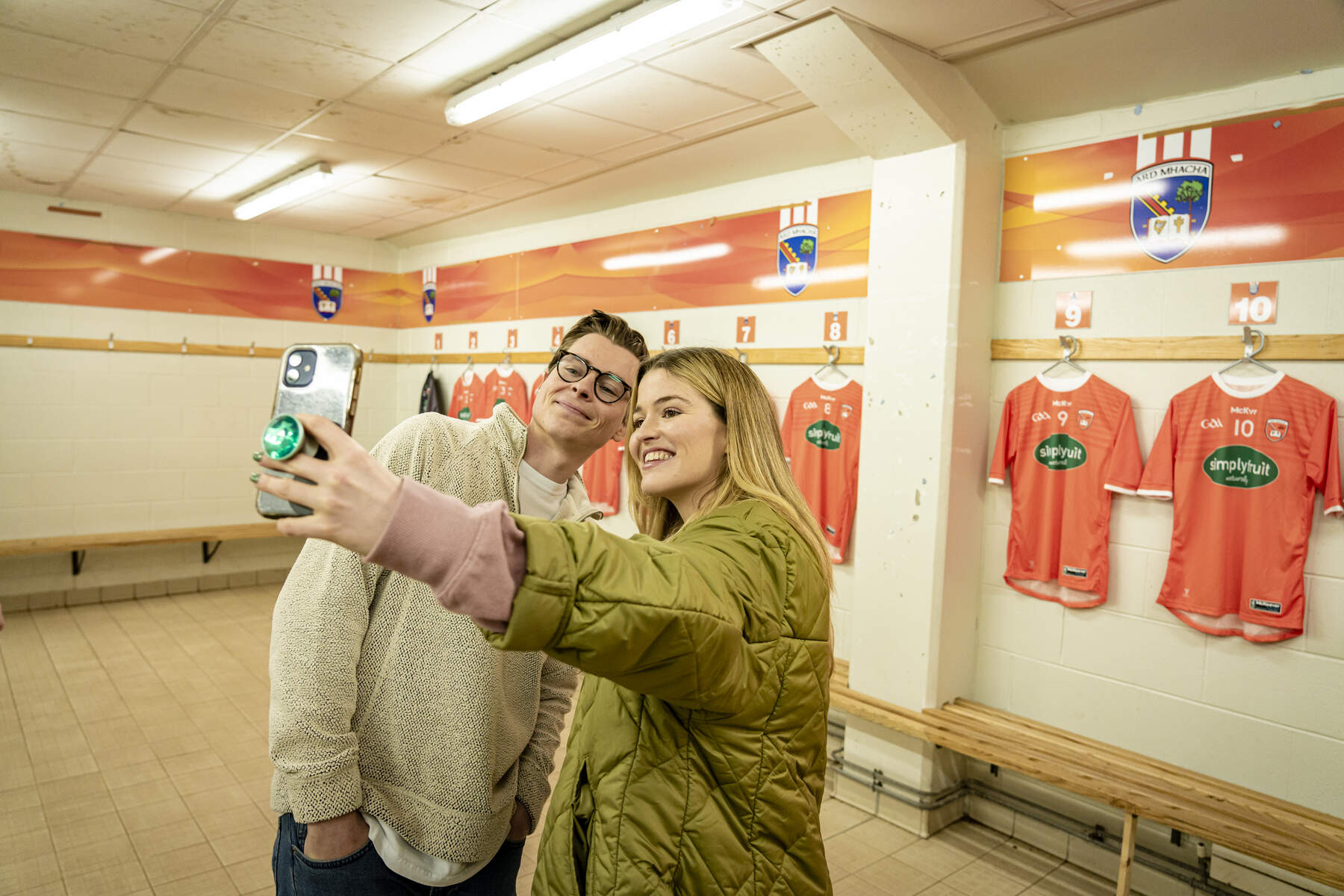 Young couple taking photos in Armagh Gaelic dressing room