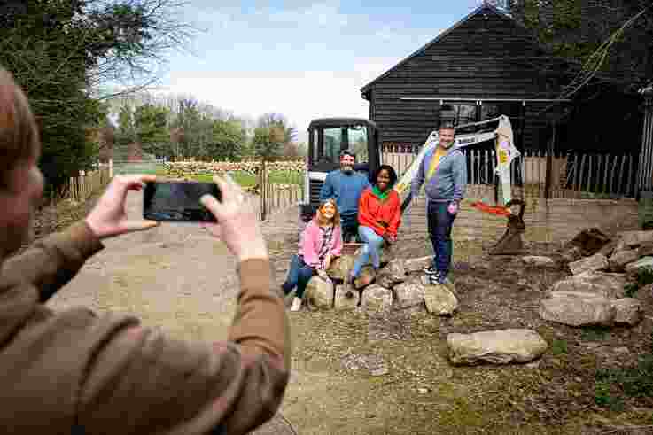 Tourists taking group photo during Dry Stone Wall Building Experience