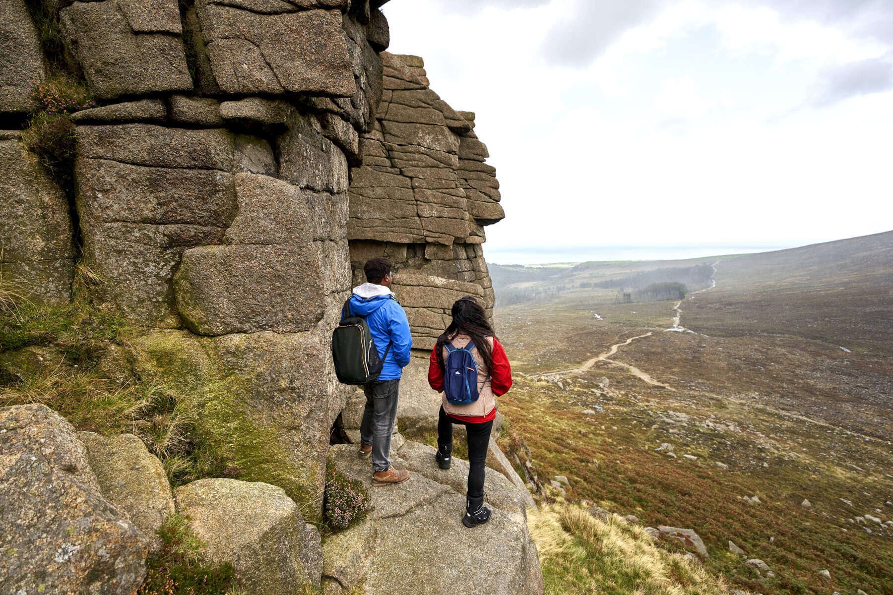 Hikers taking in the view of the Mourne Mountains