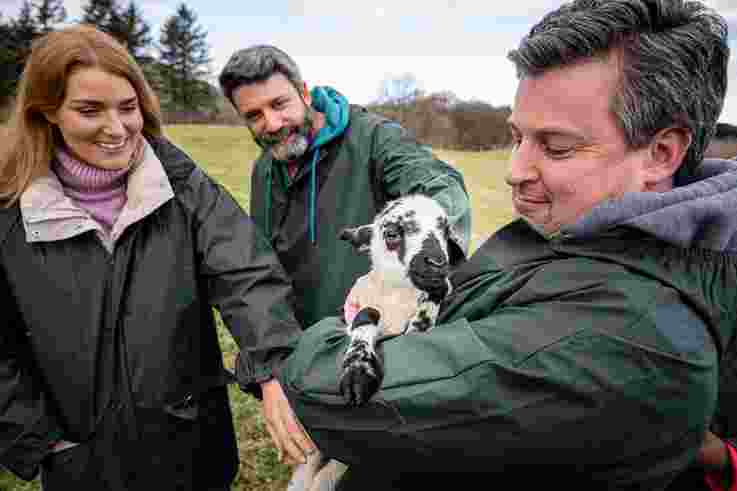 Friends holding lamb at Dunfin Farm