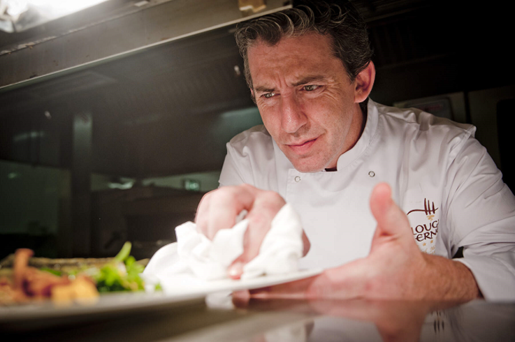 Chef preparing food dish at Lough Erne Resort, located in Fermanagh