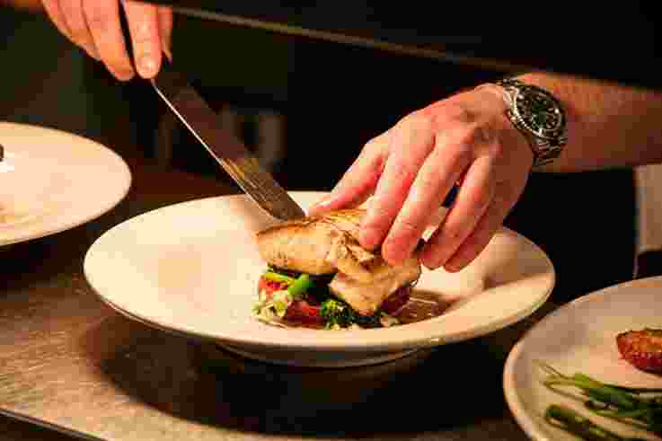 Chef preparing a fish dish at the Mourne Seafood Bar, Belfast