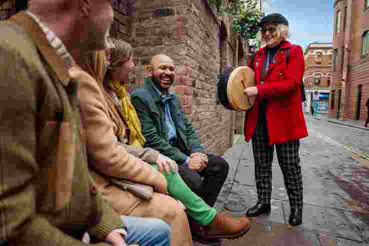 Tour guide playing bodhran as part of Belfast Music Tour