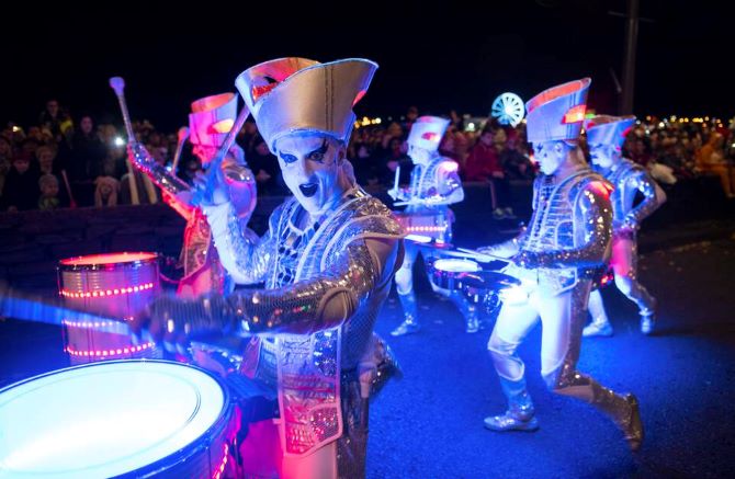 A snapshot of the halloween parade in Derry of a band playing drums dressed in unique metallic costumes