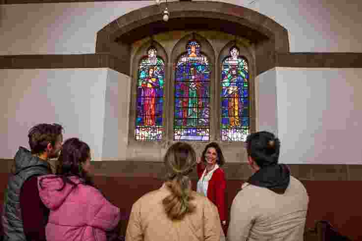 Group of Visitors at St. Marks' Church, Dundela, Belfast. this was CS Lewis’ local church in which he was baptised on 29 January 1899 and confirmed on 6 December 1914. There is a stained glass window in the church, donated by the Lewis brothers in memory of their parents, designed by the Irish artist Michael Healy.