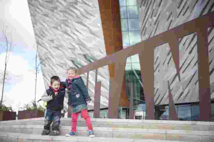 Children laughing outside Titanic Belfast.