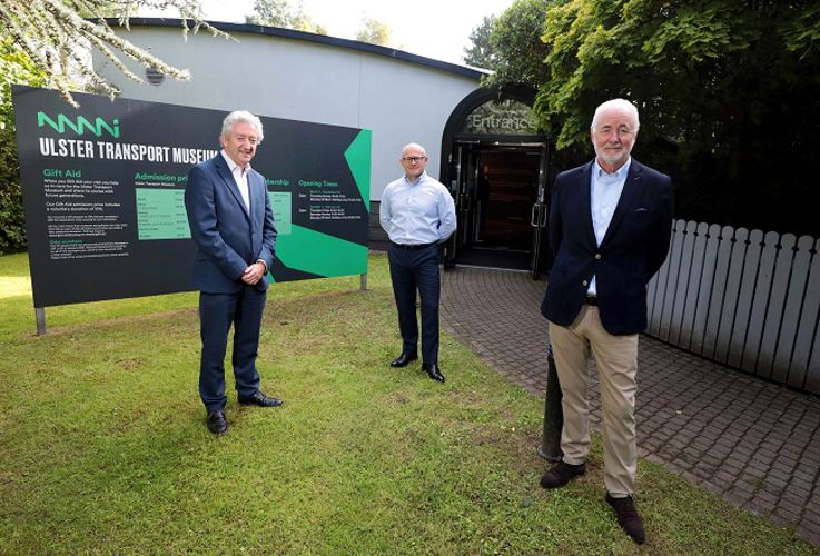 Board members pictured outside, smiling at the camera.
