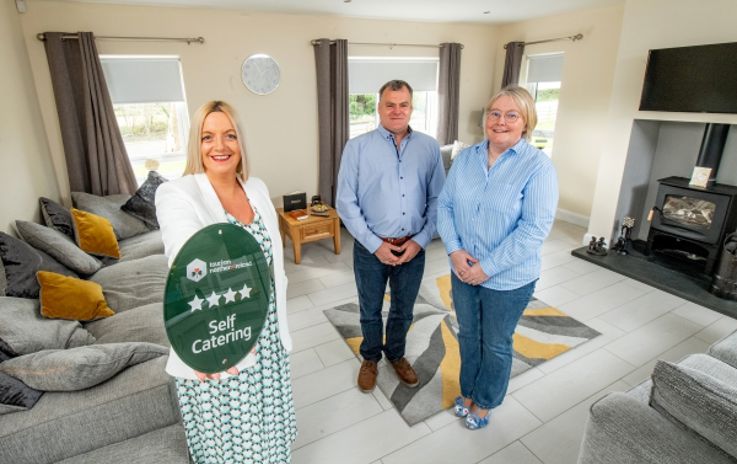 Pictured at Newell’s Cross Cottages based in Co. Down is Deborah Avery, Senior Quality Adviser at Tourism NI (left) alongside the owners, Joanne and Frank Newell.