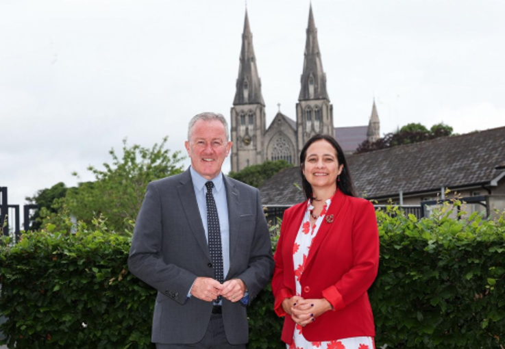  Ministers Conor Murphy and Catherine Martin pictured in Armagh, smiling at the camera. 